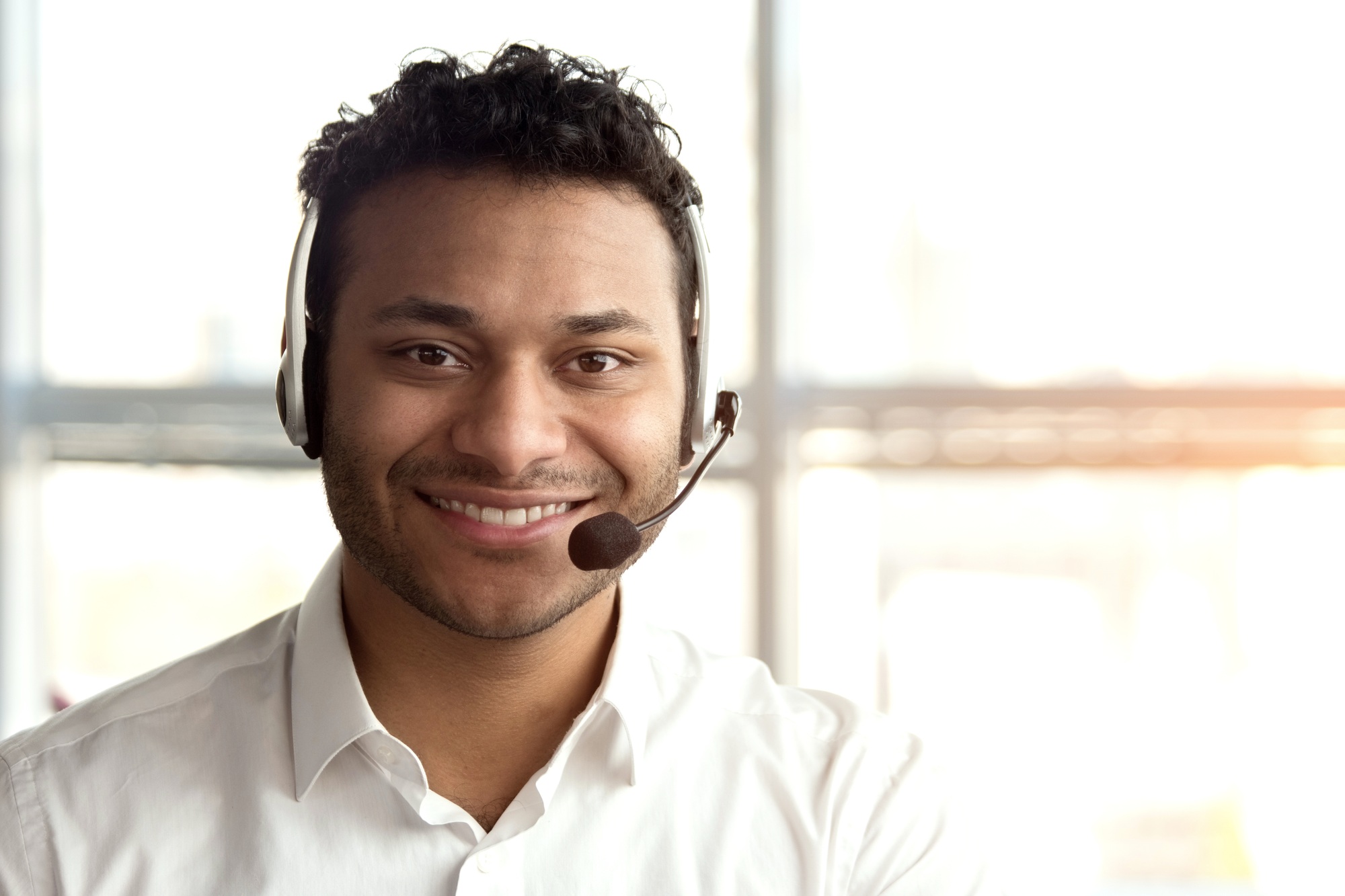 Portrait of indian operator with headset.